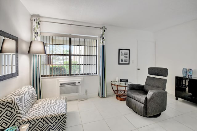 sitting room featuring a wall mounted AC and light tile patterned floors