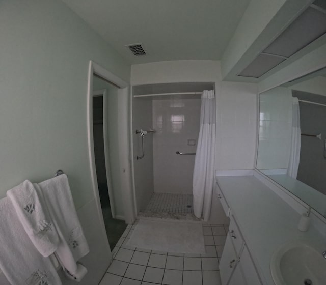 bathroom with tile patterned flooring, vanity, and curtained shower