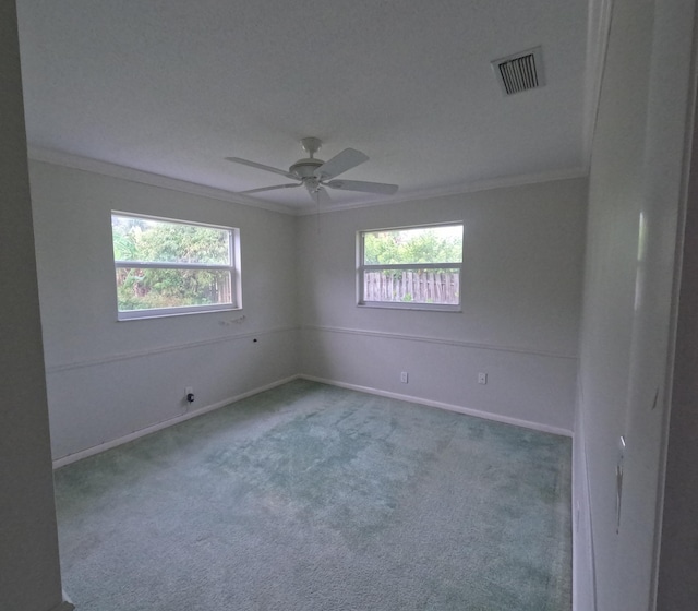 empty room with carpet, ceiling fan, and ornamental molding