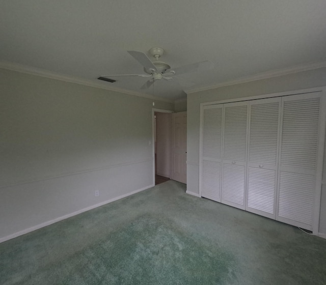 unfurnished bedroom featuring carpet flooring, a closet, ceiling fan, and crown molding