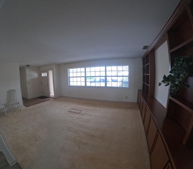 unfurnished living room with light carpet