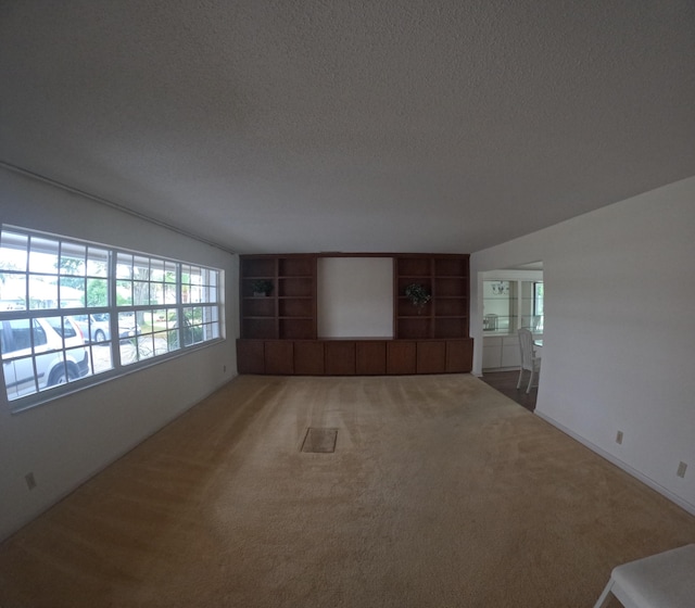 empty room featuring carpet and a textured ceiling