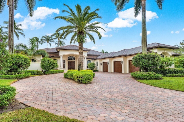 mediterranean / spanish house featuring a garage