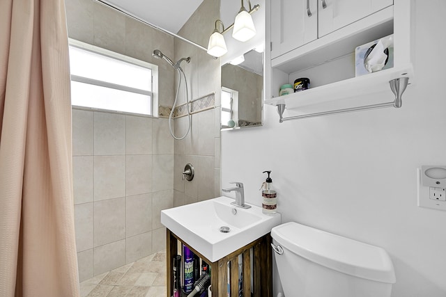 bathroom with vanity, toilet, curtained shower, and tile patterned flooring