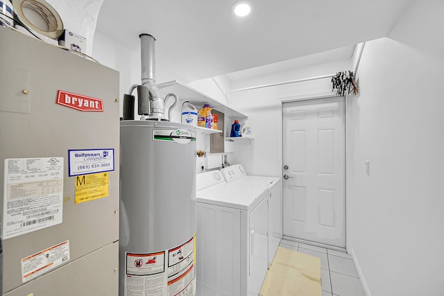 laundry room with water heater, light tile patterned flooring, and washing machine and clothes dryer