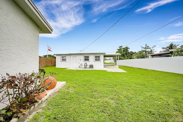 back of property featuring a yard and a patio area