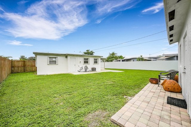 rear view of house with a yard, a patio area, and central air condition unit