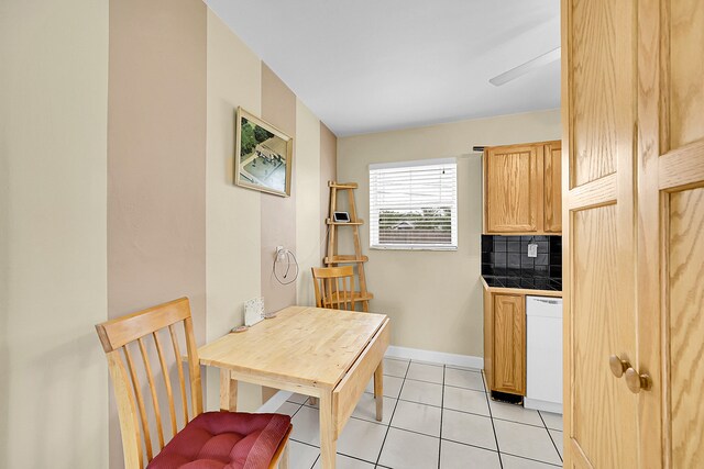 kitchen featuring tasteful backsplash, dishwasher, ceiling fan, light tile patterned floors, and light brown cabinets