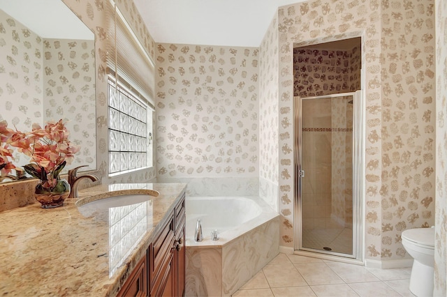 full bathroom featuring vanity, shower with separate bathtub, toilet, and tile patterned floors