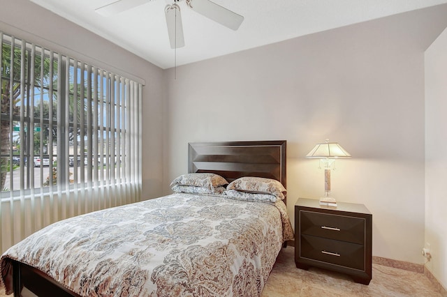 tiled bedroom featuring ceiling fan