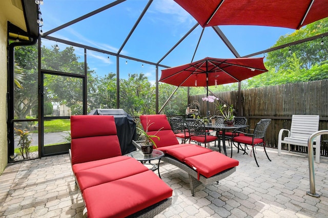 view of patio featuring glass enclosure