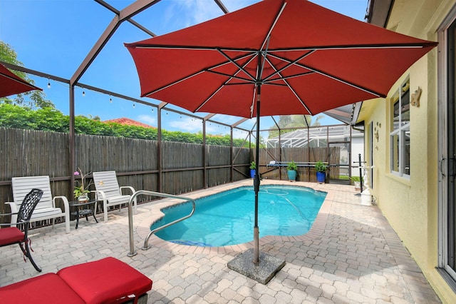 view of pool with a patio and a lanai