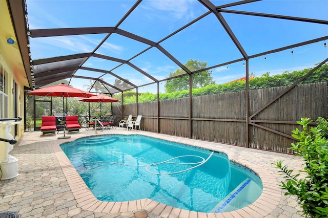 view of pool featuring a patio area and a lanai