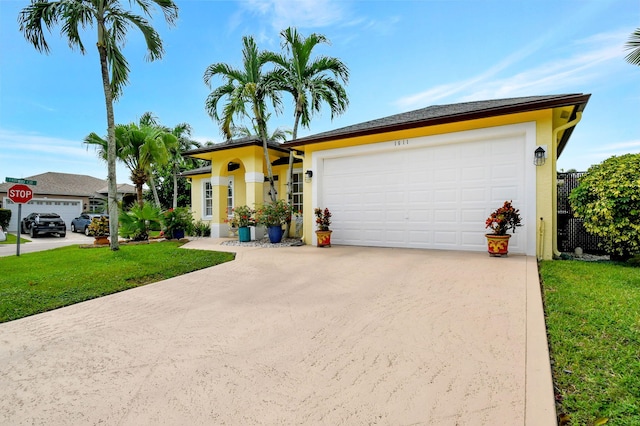 view of front of house with a garage and a front lawn