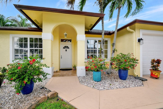 doorway to property with a garage