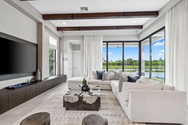 tiled living room with a water view, beamed ceiling, and plenty of natural light