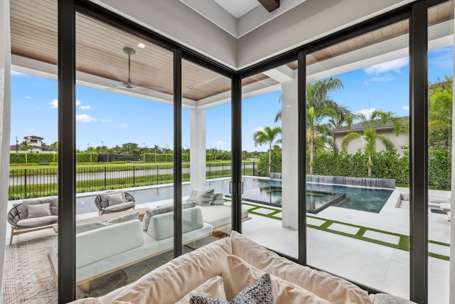 sunroom / solarium featuring a water view