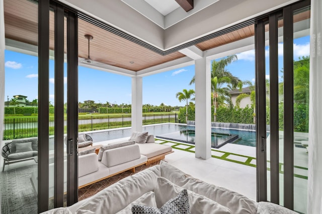 sunroom featuring a water view and a healthy amount of sunlight