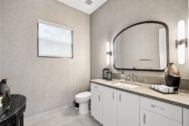 bathroom with vanity, toilet, and tile patterned flooring