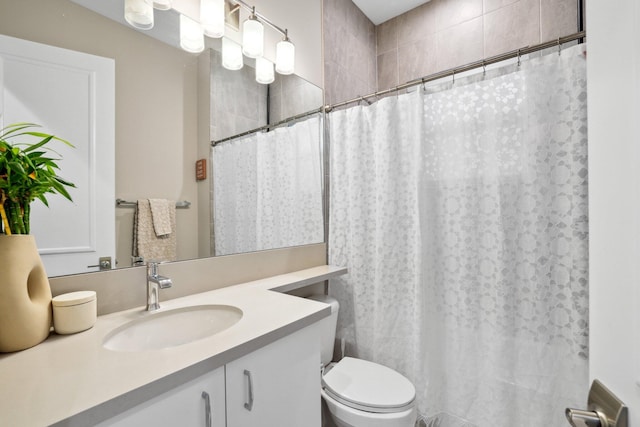 bathroom featuring vanity, curtained shower, and toilet