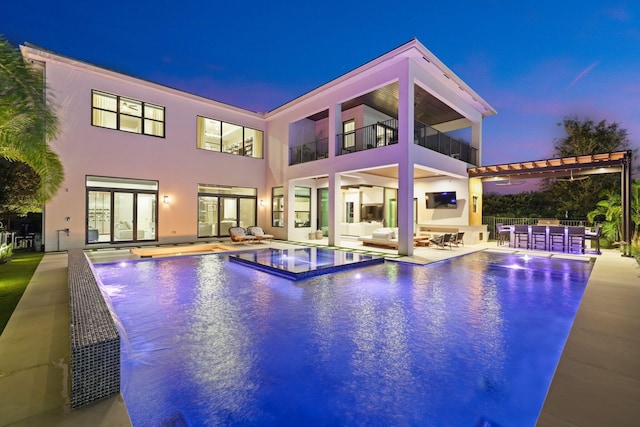 view of pool featuring a patio area, an outdoor kitchen, and an outdoor hangout area