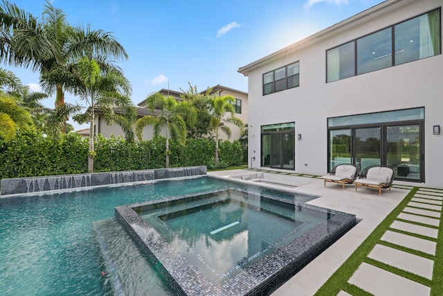 view of swimming pool with an in ground hot tub, a patio area, and pool water feature