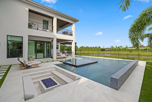 view of swimming pool featuring a patio and a water view