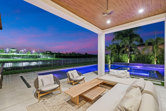 pool at dusk with a patio