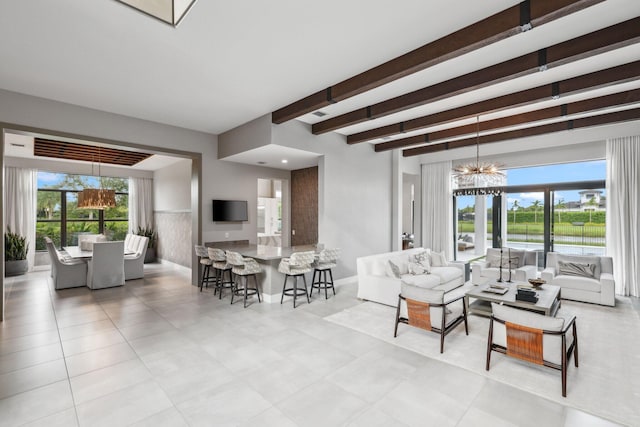 tiled living room with beam ceiling and an inviting chandelier