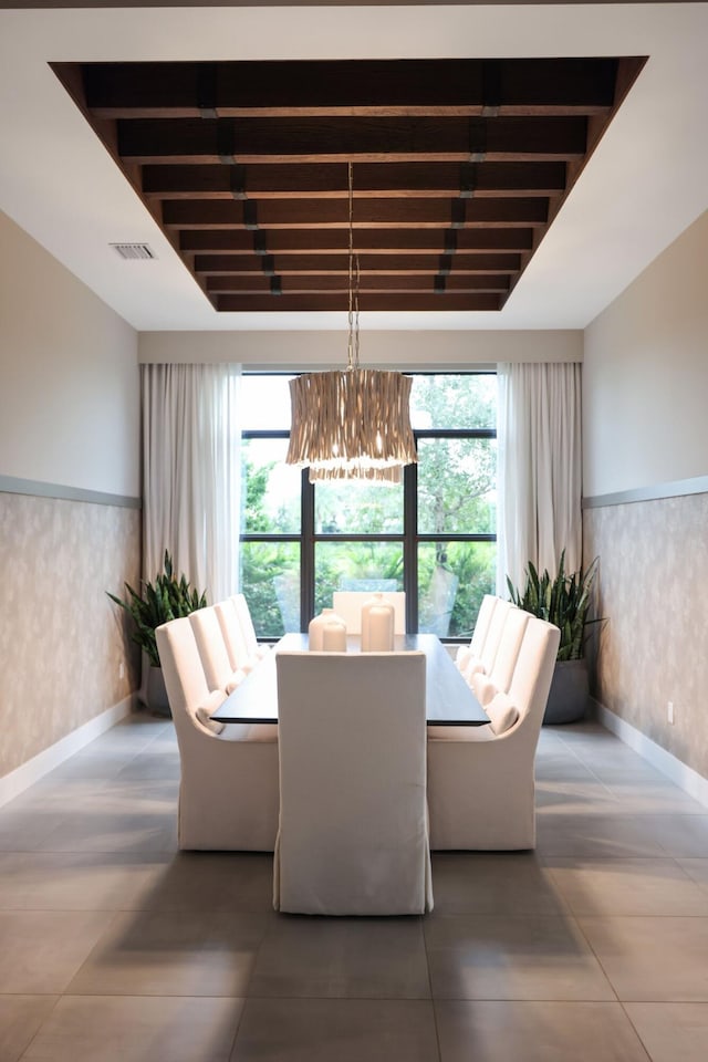 dining room with beam ceiling and a notable chandelier