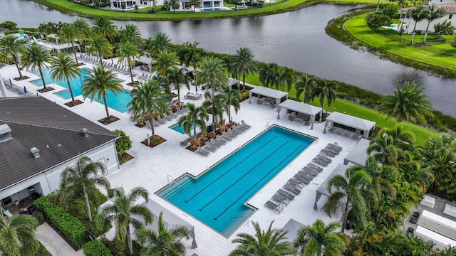 view of pool featuring a water view and a patio