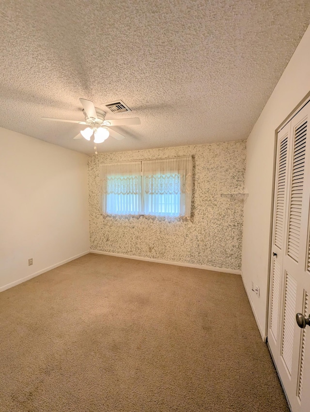 1914 Palmland Dr Unit B, Boynton Beach, FL 33436 - unfurnished bedroom featuring carpet, a closet, a textured ceiling, ceiling fan, and baseboards