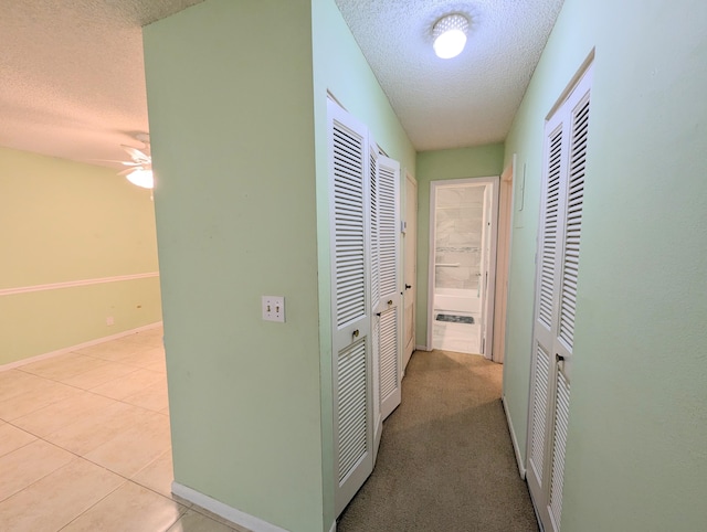 1914 Palmland Dr Unit B, Boynton Beach, FL 33436 - hall with a textured ceiling, baseboards, and tile patterned flooring