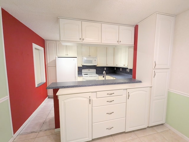 kitchen with decorative backsplash, kitchen peninsula, a textured ceiling, and white appliances