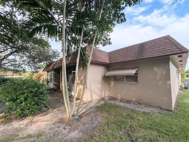 1914 Palmland Dr Unit B, Boynton Beach, FL 33436 - view of property exterior featuring stucco siding, mansard roof, and roof with shingles