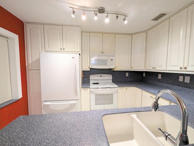 1914 Palmland Dr Unit B, Boynton Beach, FL 33436 - kitchen featuring white appliances, a sink, dark countertops, and a textured ceiling
