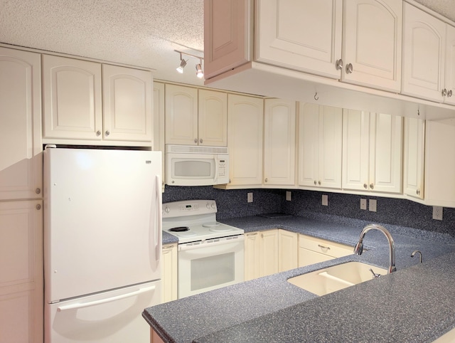 1914 Palmland Dr Unit B, Boynton Beach, FL 33436 - kitchen with white appliances, a sink, dark countertops, cream cabinets, and a textured ceiling