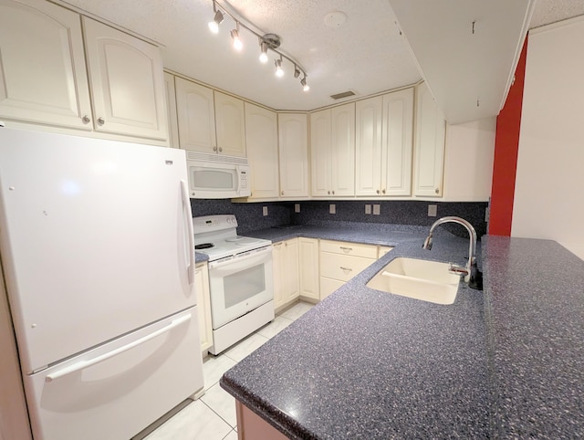 1914 Palmland Dr Unit B, Boynton Beach, FL 33436 - kitchen featuring white appliances, a sink, dark countertops, light tile patterned flooring, and a textured ceiling