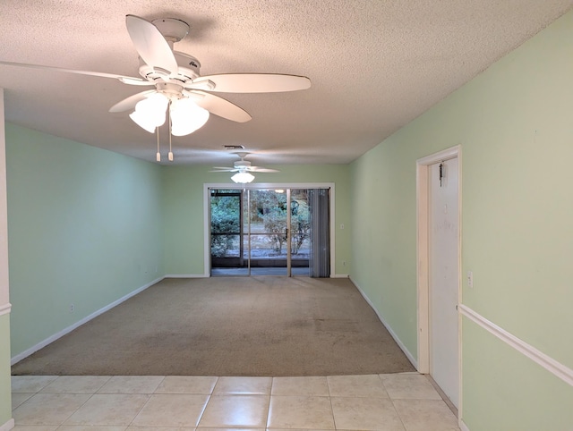 1914 Palmland Dr Unit B, Boynton Beach, FL 33436 - spare room featuring light colored carpet, a ceiling fan, a textured ceiling, baseboards, and light tile patterned flooring