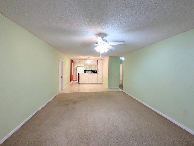 1914 Palmland Dr Unit B, Boynton Beach, FL 33436 - unfurnished living room with light carpet, baseboards, a ceiling fan, and a textured ceiling