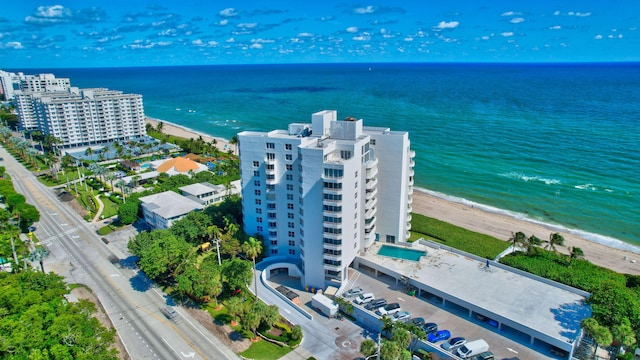 drone / aerial view with a water view and a view of the beach