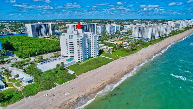 bird's eye view with a water view and a beach view