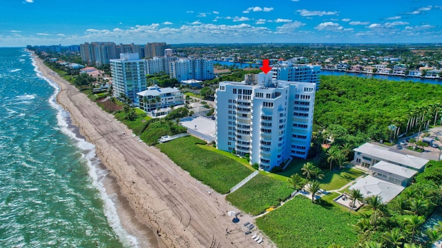 bird's eye view featuring a water view and a beach view