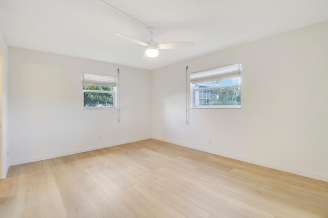 empty room with light hardwood / wood-style flooring and ceiling fan