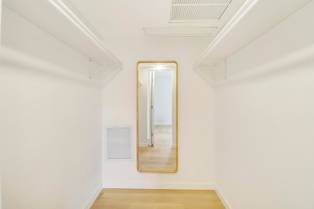 spacious closet featuring hardwood / wood-style floors