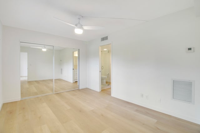 unfurnished bedroom featuring light hardwood / wood-style floors, a closet, and ceiling fan