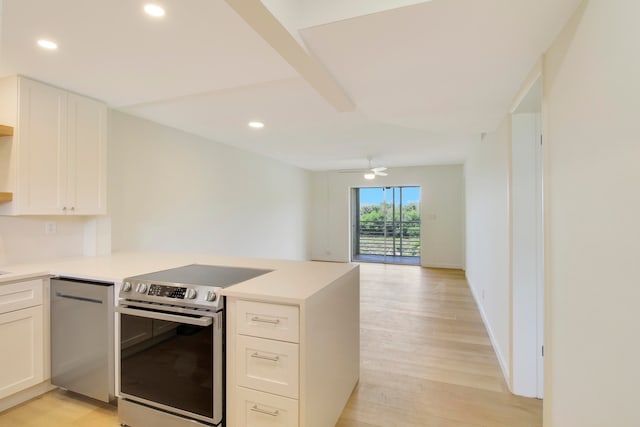 kitchen with kitchen peninsula, ceiling fan, white cabinetry, stainless steel electric range oven, and light wood-type flooring