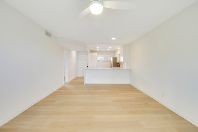 empty room with light wood-type flooring and ceiling fan