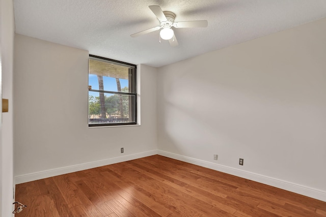 unfurnished room with a textured ceiling, hardwood / wood-style flooring, and ceiling fan