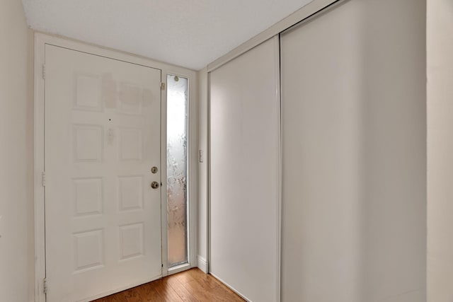 foyer with a textured ceiling and hardwood / wood-style flooring